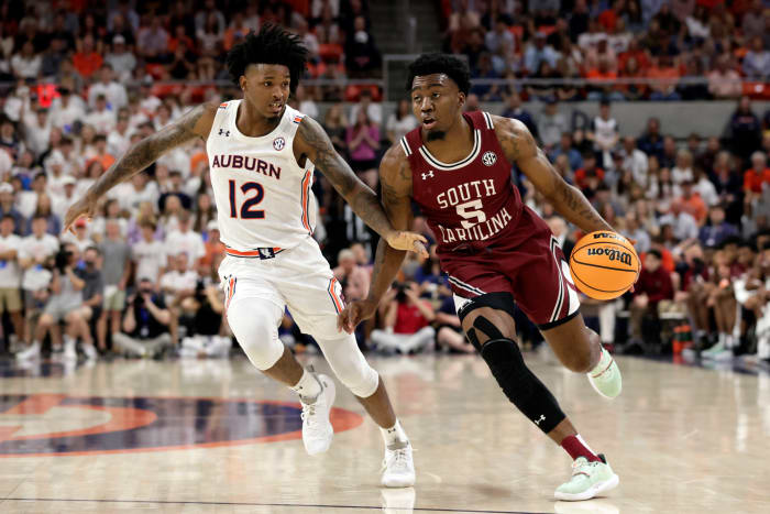 South Carolina guard Jermaine Couisnard (5) dribbles around Auburn guard Zep Jasper (12) as he goes to the basket during the first half of an NCAA college basketball game Saturday, March 5, 2022, in Auburn, Ala. (AP Photo/Butch Dill)